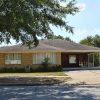 Single-story brick house with carport and wheelchair ramp