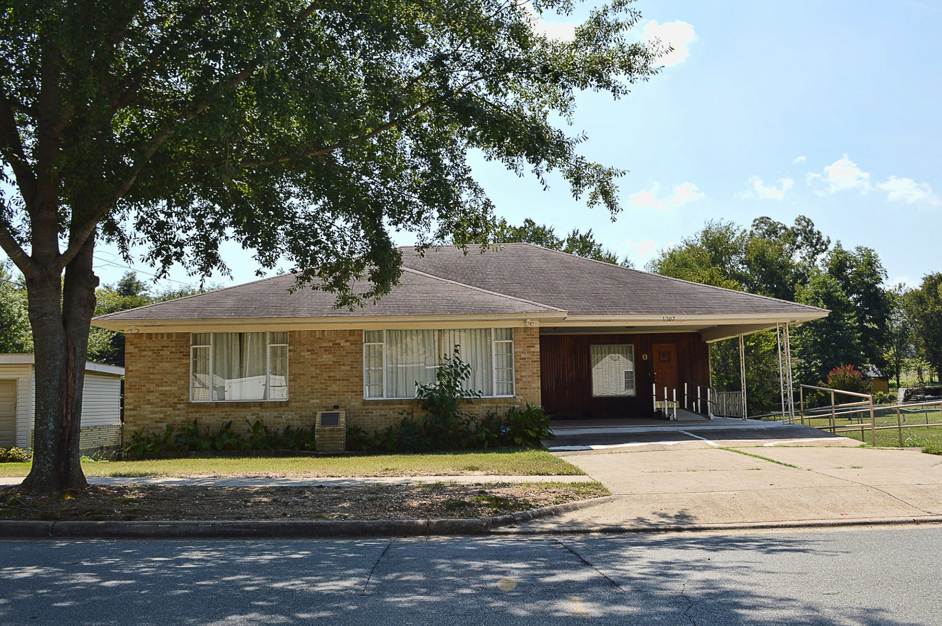 Single-story brick house with carport and wheelchair ramp