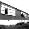 Side of brick school building with air conditioning units