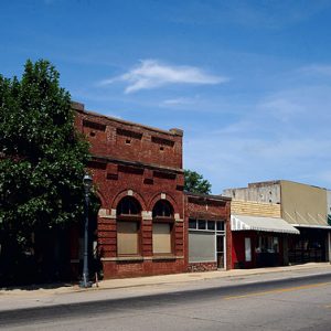 Brick storefronts with awnings on multilane street