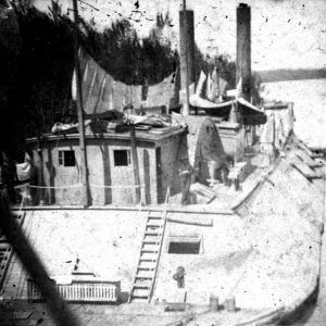 Clothes hanging on deck of Naval steam boat with guns