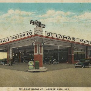 Cars parked under canopy at dealership building