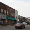 Multistory brick storefront buildings with sidewalk on street