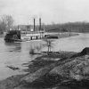 steamboat pushing barge on river