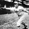 Man in St. Louis Cardinal uniform throwing a pitch in crowded stadium