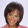 African-American woman with earrings and pink suit