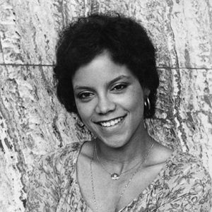 Young smiling African-American woman in flowered top with necklaces