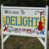 "Welcome to Delight Home of Glen Campbell" sign with guitar art