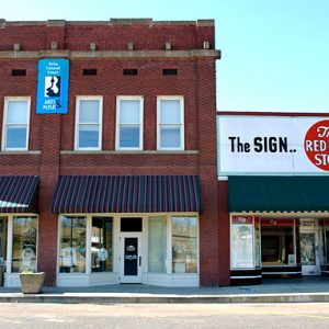 Two-story brick and single-story storefront on street