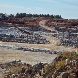 Dirt roads and quarried rocks on sloping landscape