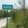 Green "Denton" sign on two-lane road