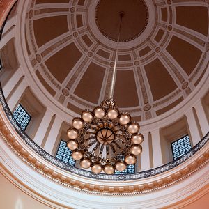 View of ceiling including dome and chandelier