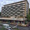 Multistory hotel building with covered sidewalk on city street