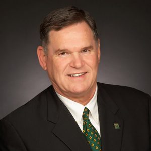 smiling white man in suit jacket and tie