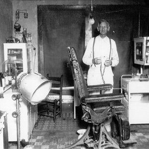 Older white man with glasses in examination room with chair