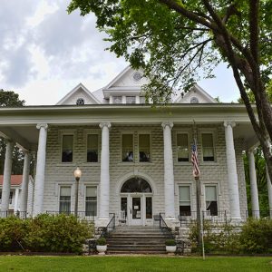 Multistory house with covered porch supported by tall columns