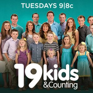 Promotional photograph of white man woman and 19 young and teen children standing together with white text