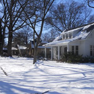 Two-story white house and neighborhood in snow