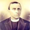 white man in priest's collar and glasses