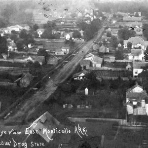 Looking over street through residential neighborhood lined with houses and outbuildings