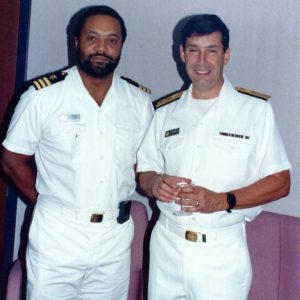 African American man with beard and white man in matching uniforms standing together