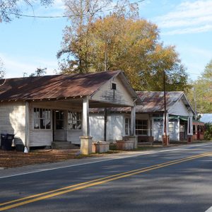 Row of storefronts with covered entrances on street