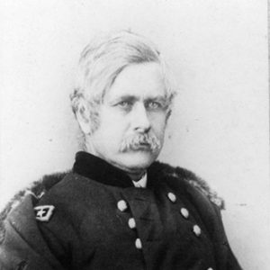 White man with mustache sitting in military uniform