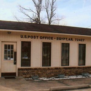 Single-story brick building with parking lot "U.S. Post Office Egypt"