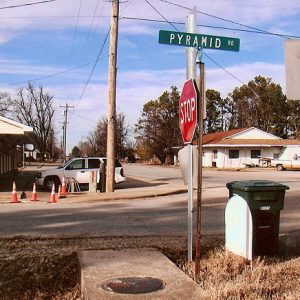 Street intersection with signs and single-story buildings