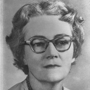 White woman with glasses and bead necklace