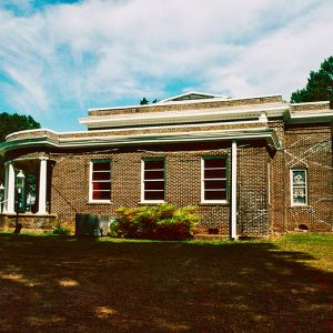 Single-story brick building with front porch and columns