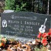 "Melvin L Endsley" gravestone with guitar engraving and portrait on it in cemetery