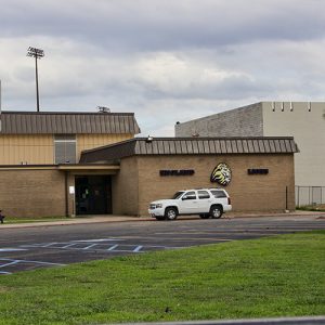 Multistory brick school buildings with parking lot