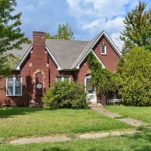 Brick house with trees and bushes