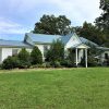 Church building with blue roof and white siding