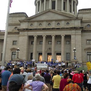 Crowd of people on steps of multistory building with dome