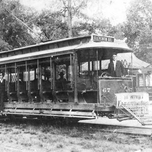 White men in uniform on trolley car at station