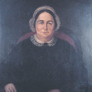 Painting of older white woman in black with black hair with brooch in red chair