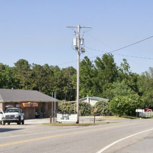 Side of gas station and building on paved road