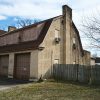 Multistory building with two garage bays and gambrel roof