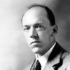 Middle-aged white man posing in suit and tie