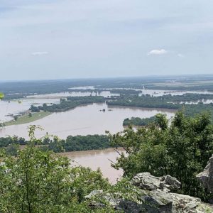 Flooded river valley seen from elevated rocky outcropping