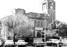 Brick building labeled "Franklin County Court House" with clock tower and parking lot