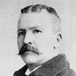 White man with mustache in suit