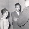 African-American man and white woman talking to white man in suit