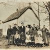 White students and faculty outside single-story building