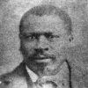 African-American man with mustache in suit and bow tie