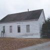 Side view of single story building with wood siding