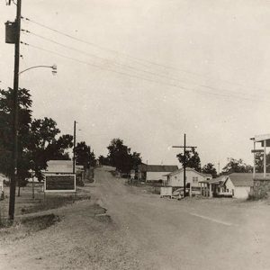 Single-story buildings and truck on town street