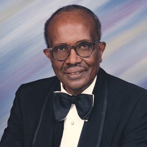 African-American man with mustache in suit and bow tie